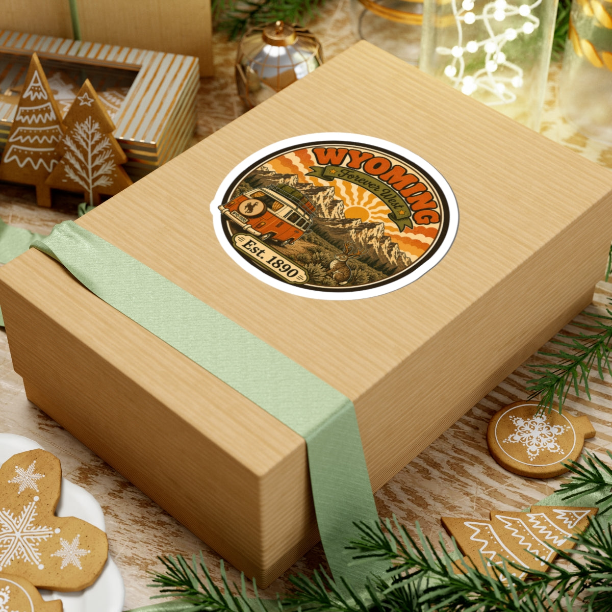White oval sticker with Wyoming vintage van, mountain range, Est. 1890 on gift box
