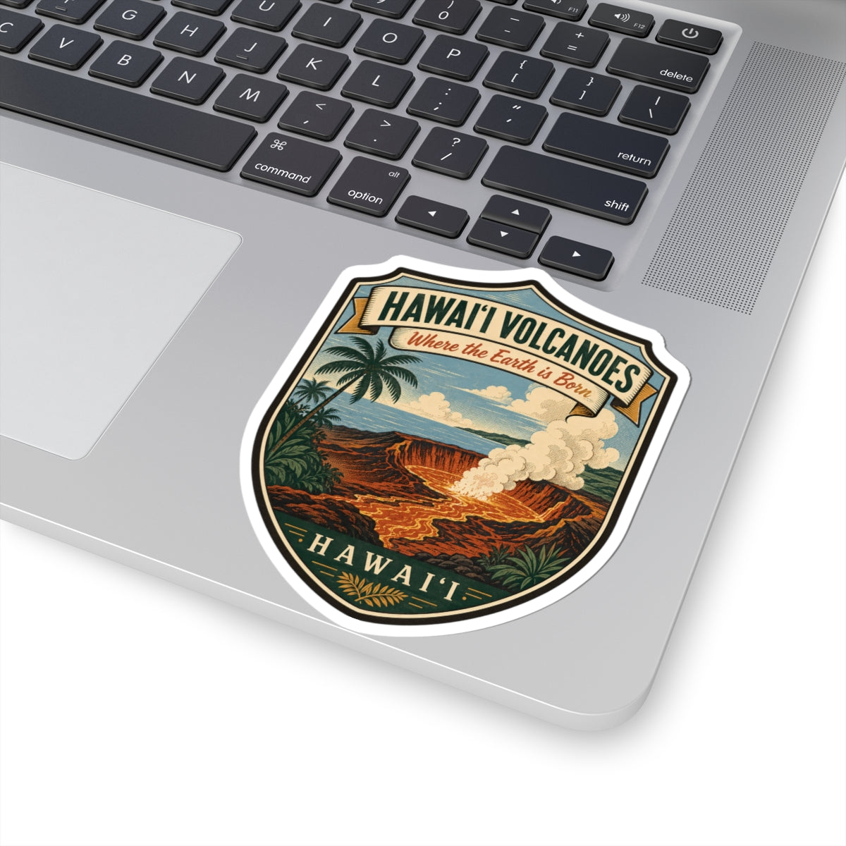 Die-cut travel sticker showing Hawai'i Volcanoes shield with palm trees and lava