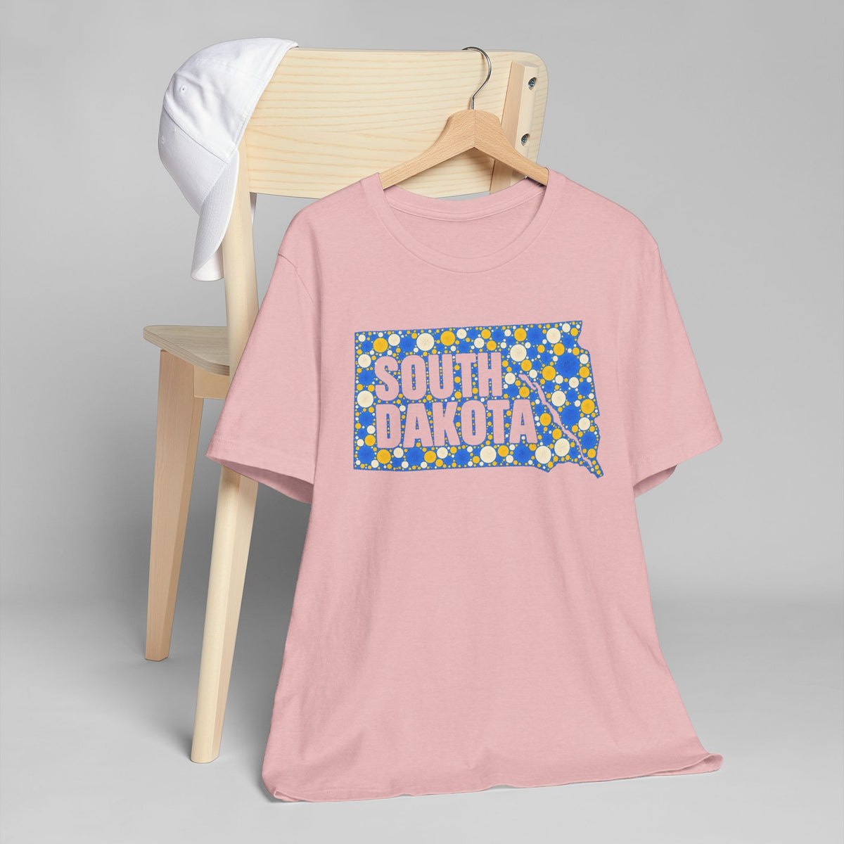 Dusty pink crew-neck t-shirt with colorful South Dakota map graphic on front.