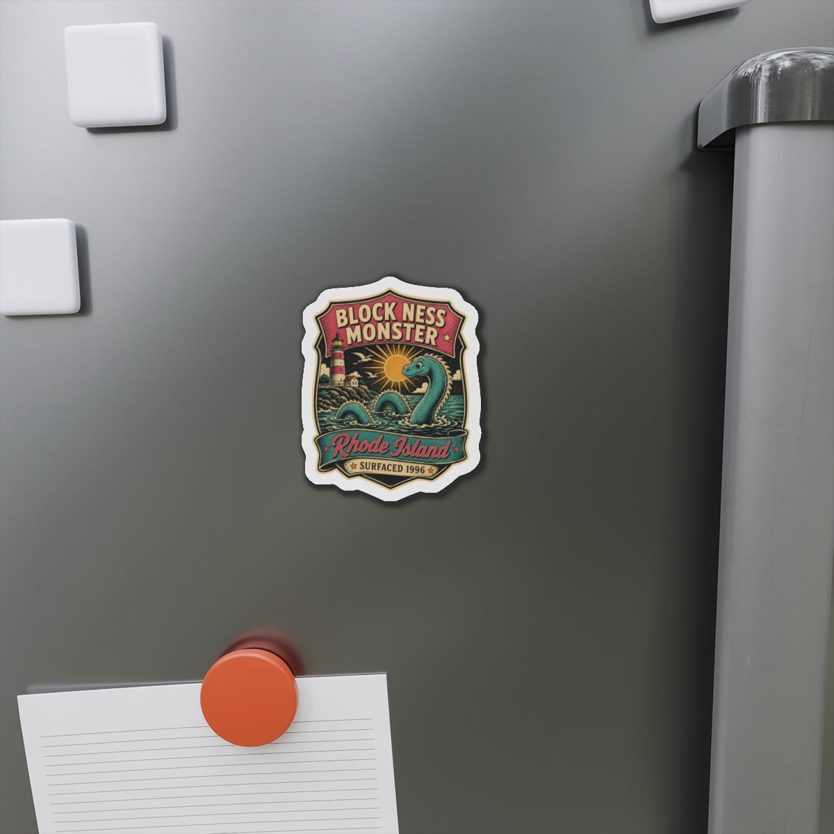 Die-cut magnet sticker on stainless fridge door with teal sea creature and Rhode Island banner