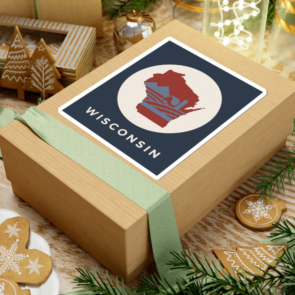 Wisconsin badge sticker on wrapped gift: red map in cream circle with WISCONSIN text