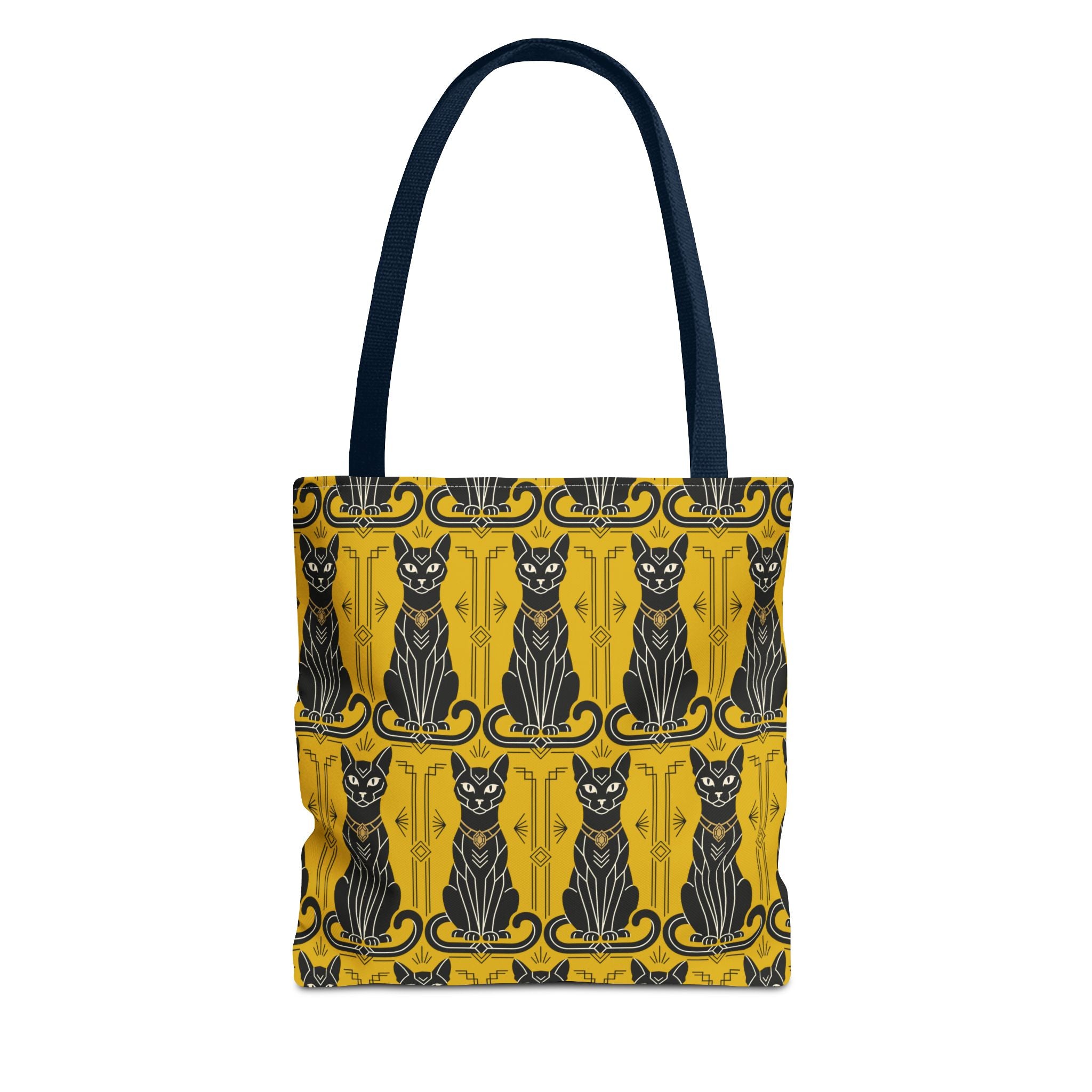 Yellow tote bag with repeating black cat faces and ornate border; navy shoulder straps