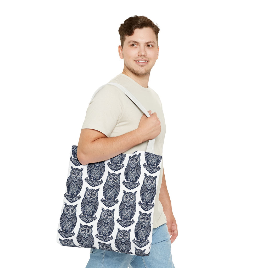 Tote bag with repeating navy owl pattern and white handles, held on shoulder