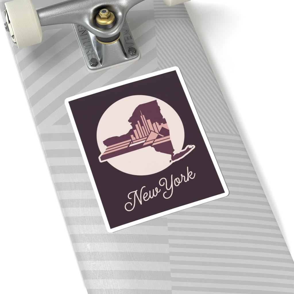 New York skyline decal sticker on a striped suitcase surface, with circular state silhouette and cursive “New York”.
