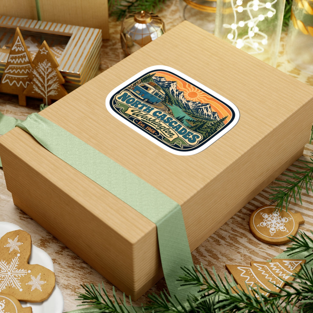 North Cascades sticker on a wooden gift box with green ribbon and mountain artwork