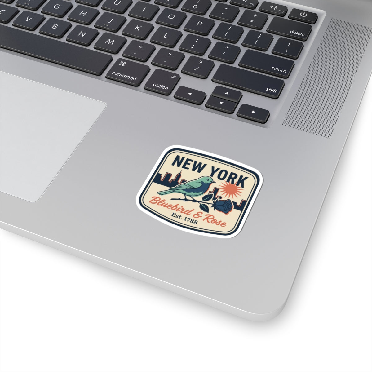 Square vintage New York sticker with bluebird, rose flowers, and gold banner text