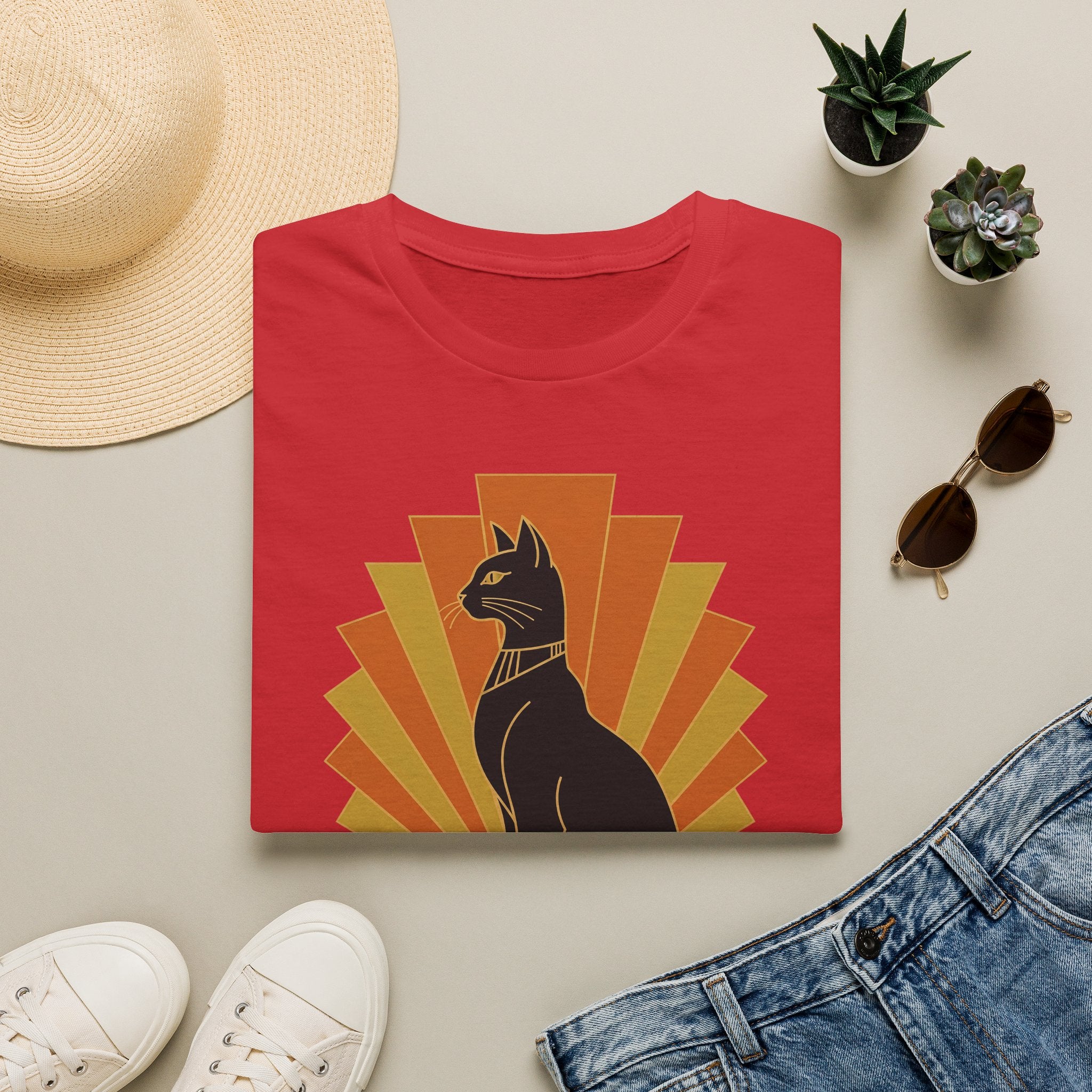 Red T-shirt with black Egyptian cat headdress, orange and yellow sunburst graphic.