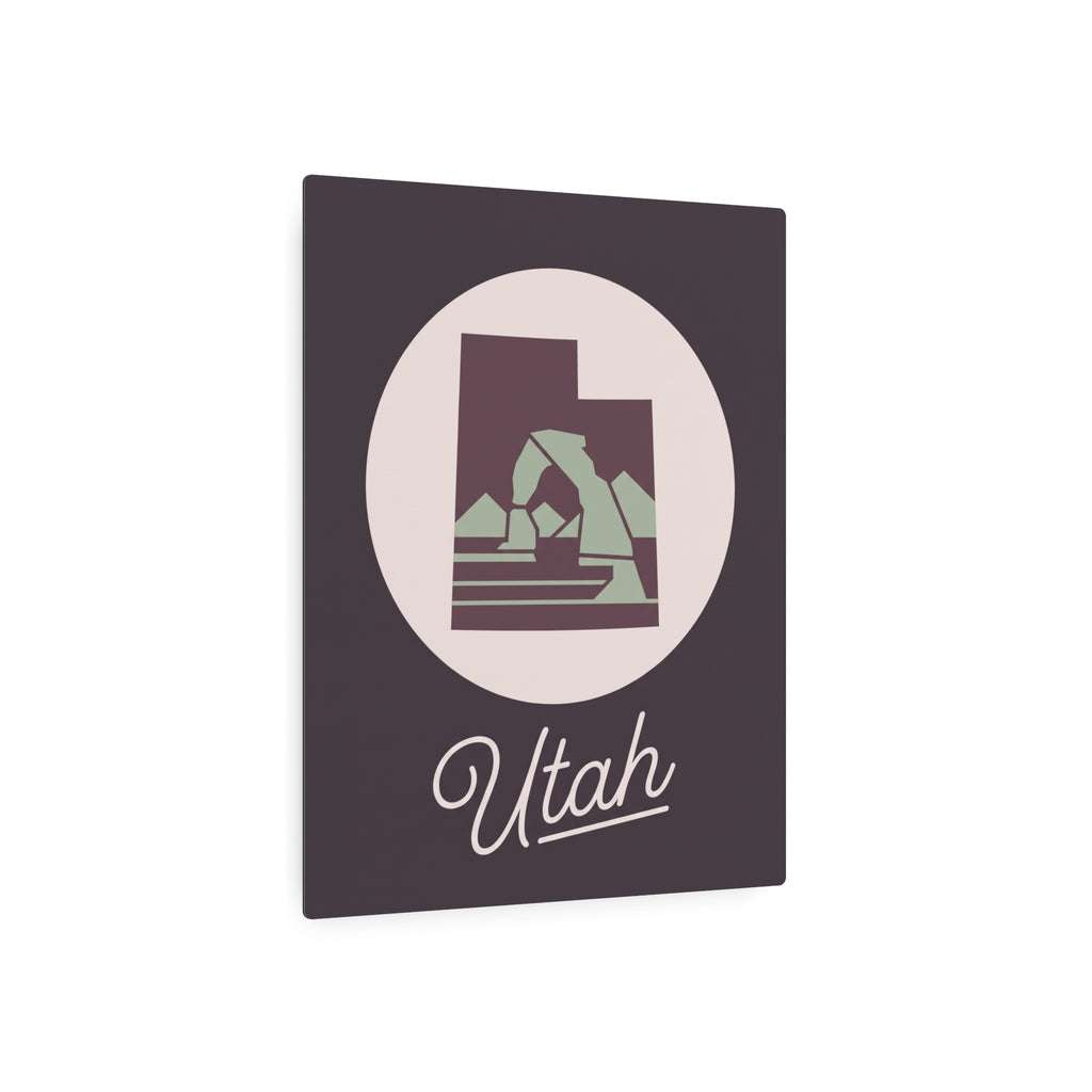 Dark square metal wall plaque with circular Utah silhouette and script “Utah”