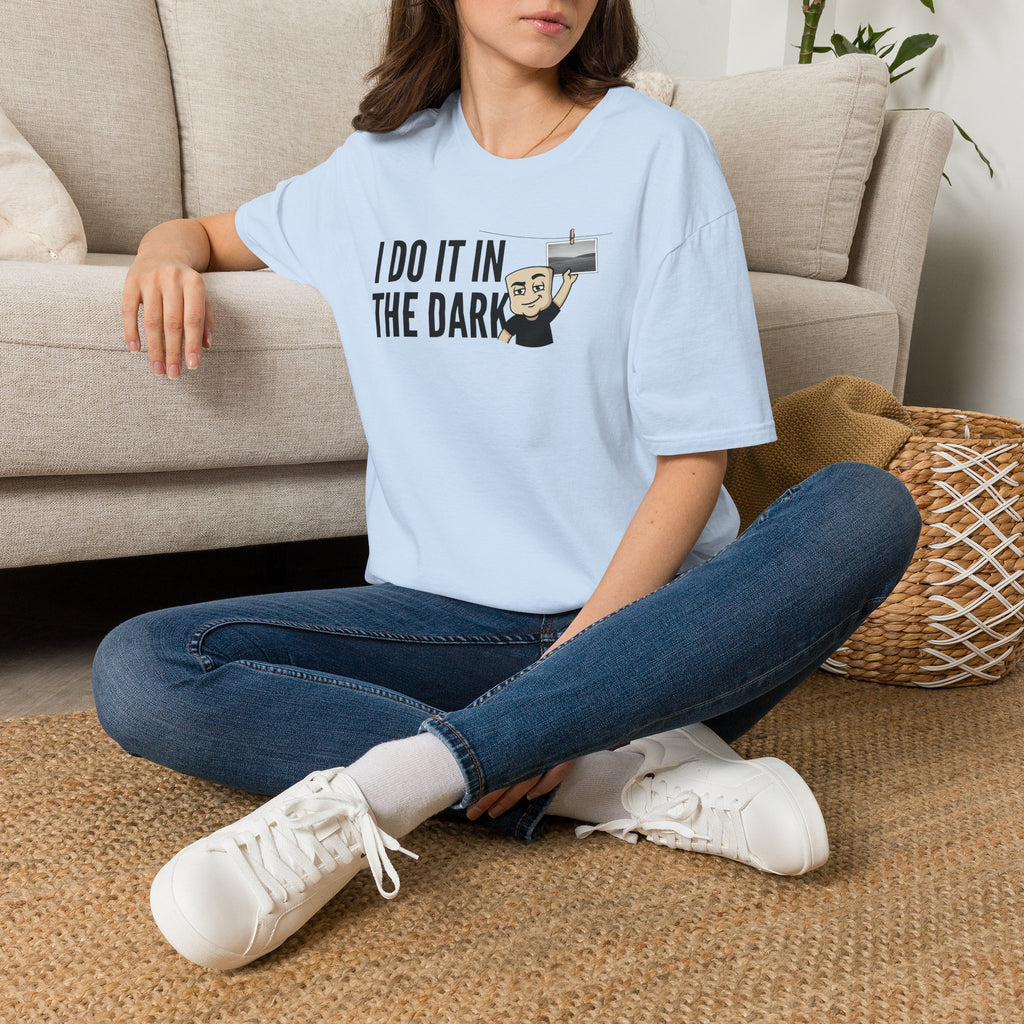 Light blue t-shirt with “I DO IT IN THE DARK” camera graphic on the chest