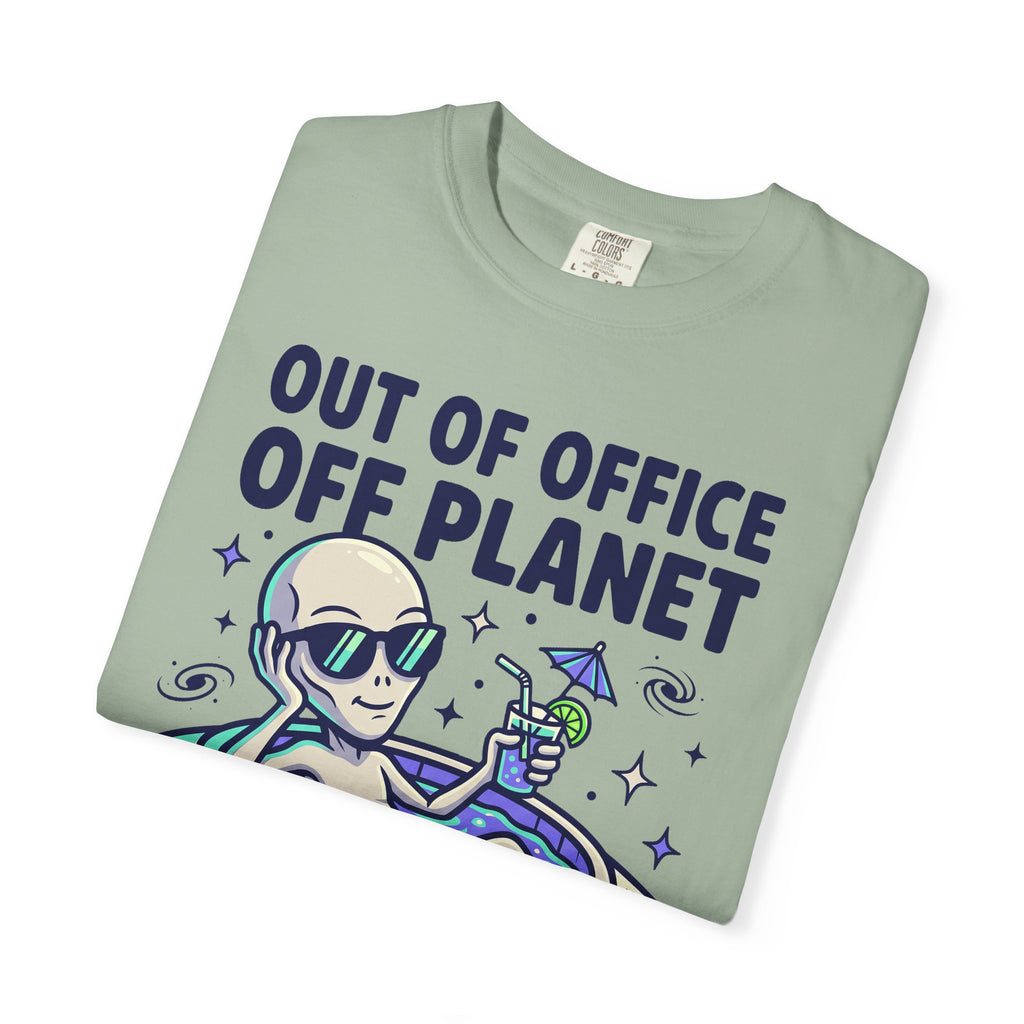 Sage green alien graphic T-shirt with floatie and 'OUT OF OFFICE OFF PLANET' text