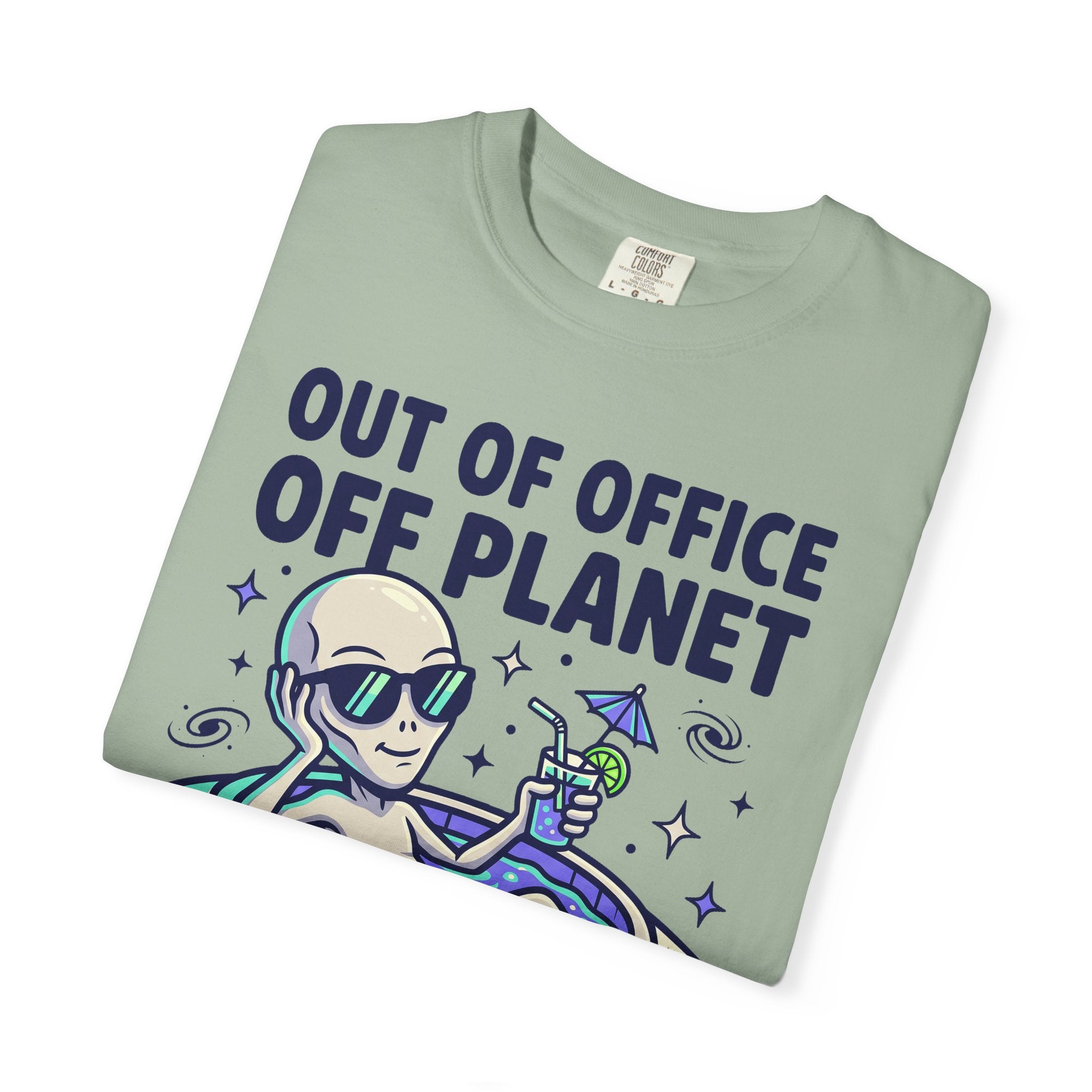 Sage green alien graphic T-shirt with floatie and 'OUT OF OFFICE OFF PLANET' text