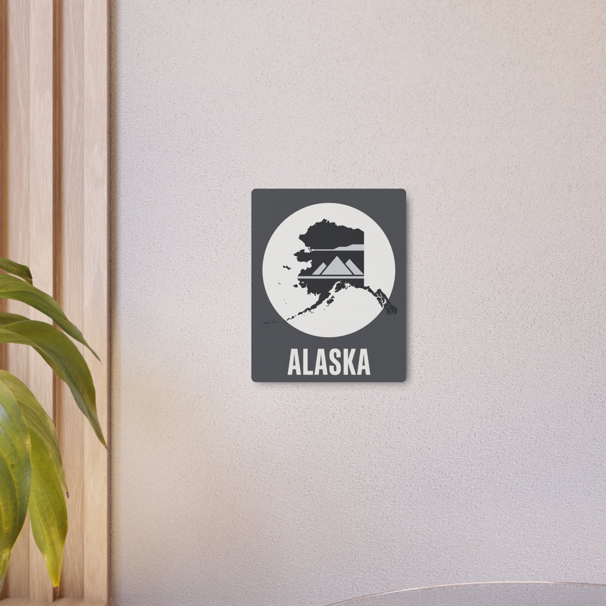 Alaska metal wall art with circular map graphic and ALASKA lettering on dark gray square