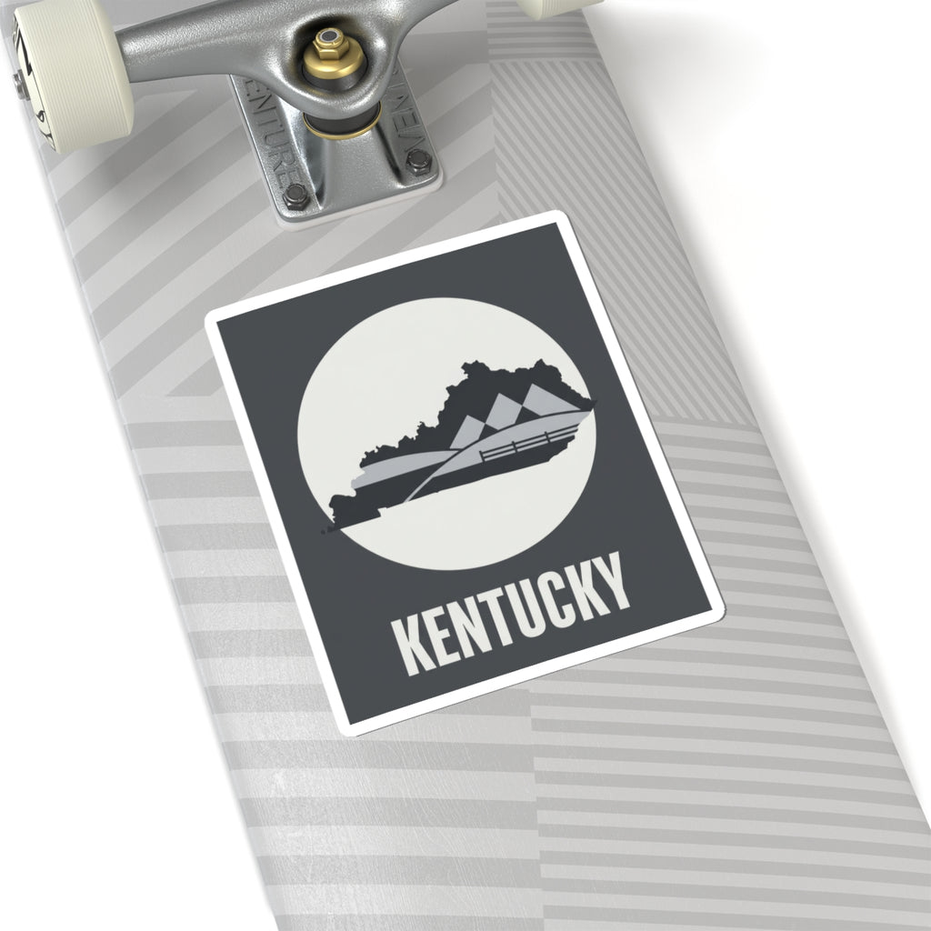 Kentucky vinyl sticker on car dashboard, dark gray square with white border and KENTUCKY