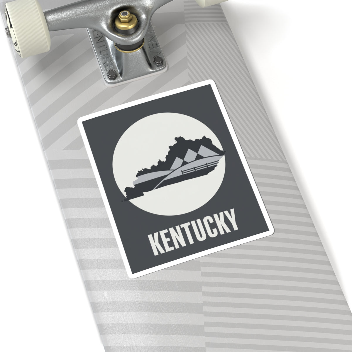 Kentucky vinyl sticker on car dashboard, dark gray square with white border and KENTUCKY
