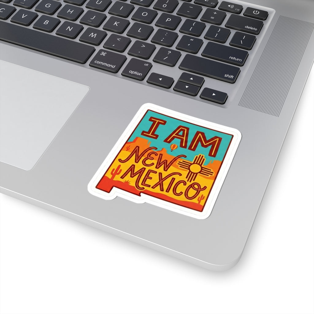 New Mexico kiss-cut sticker on white backing: “I AM” over “NEW MEXICO” with sun