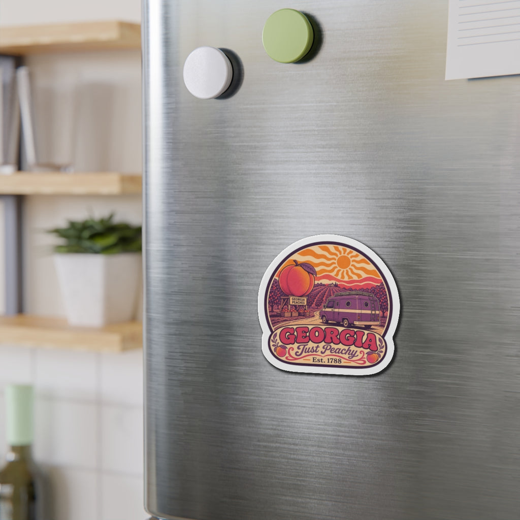 Die-cut magnet on fridge, 'GEORGIA' banner with peach and van scene plus orange sun details