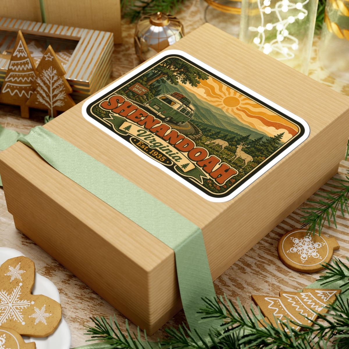 Kiss-cut sticker on a wrapped present: rounded white border with retro green camper and mountains graphic