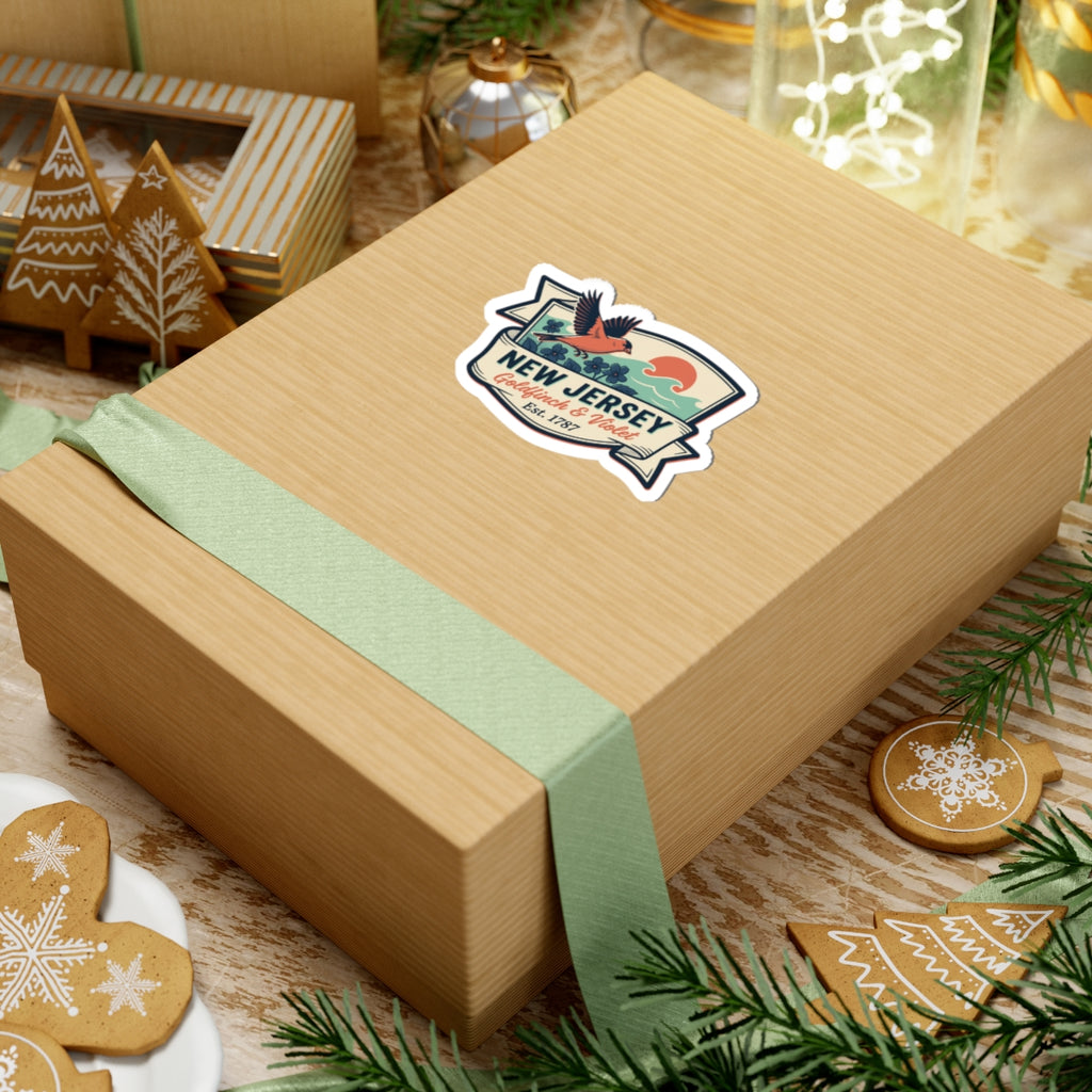 New Jersey badge sticker on a wrapped gift box lid, “Goldfinch & Violet” visible.
