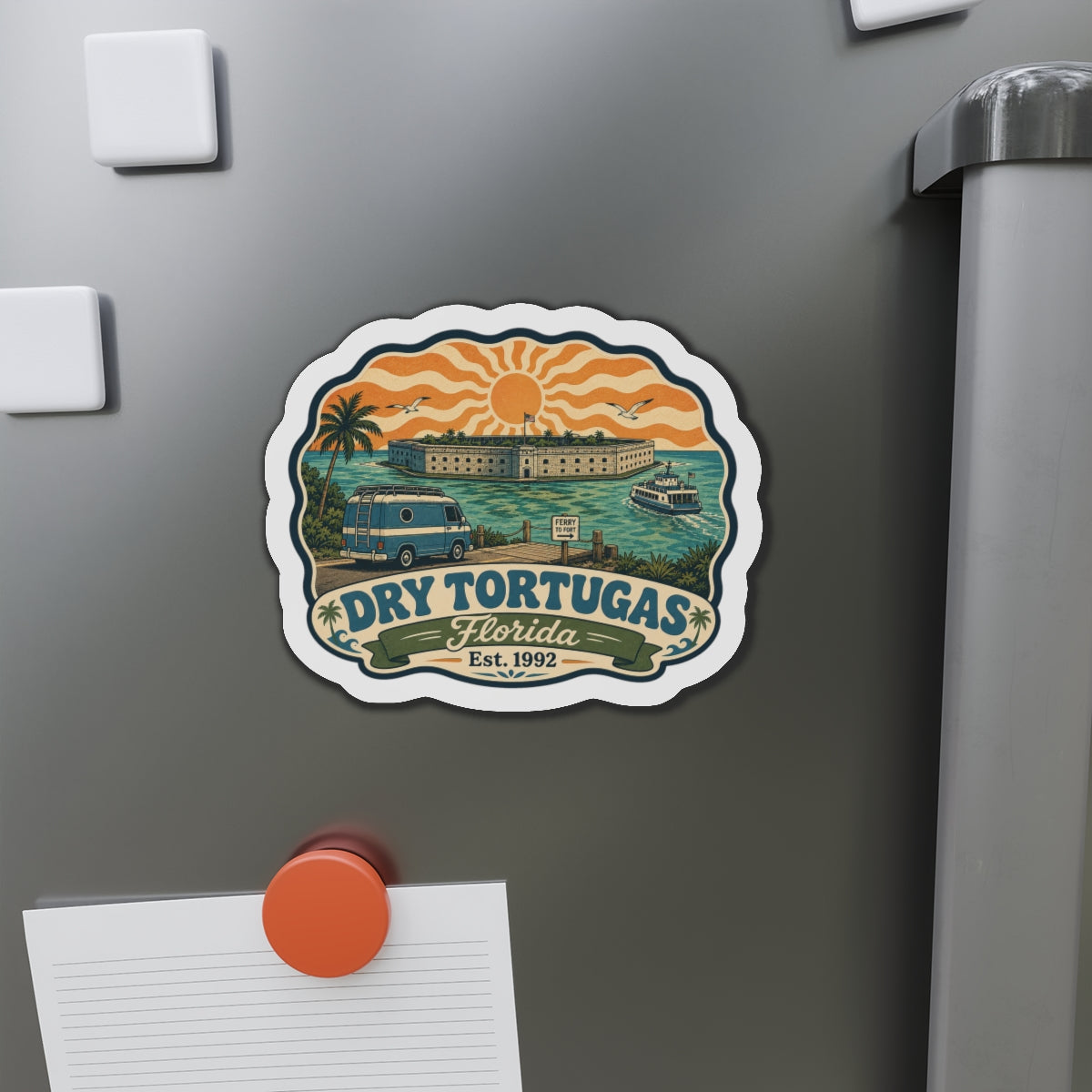 Die-cut retro fridge magnet featuring a coastal scene with boats and orange sunset