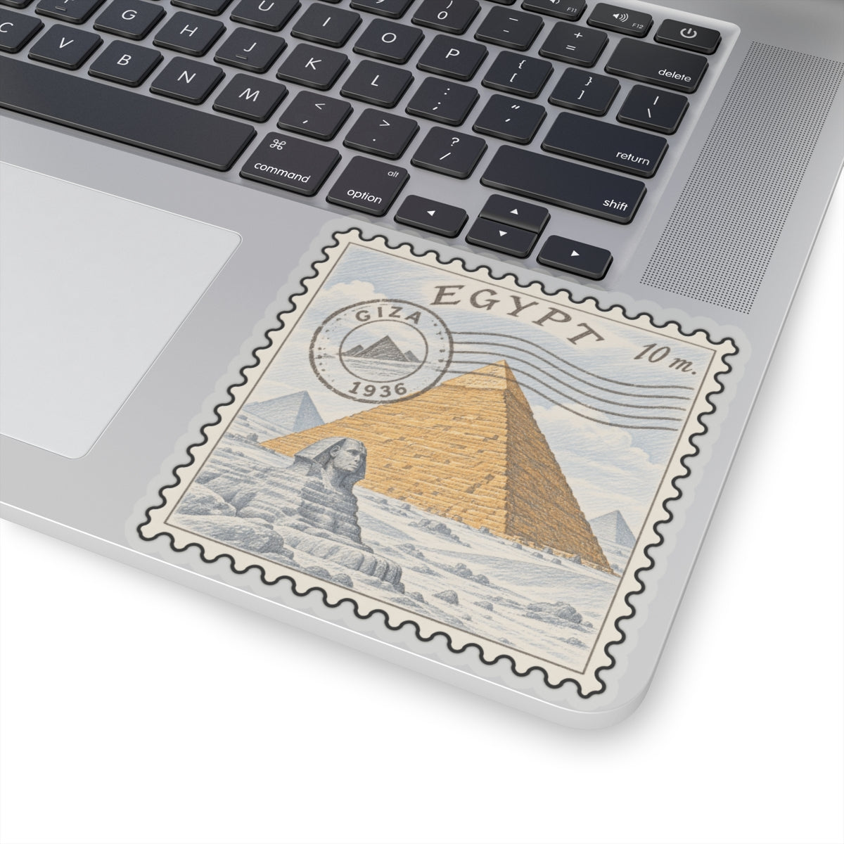 Egypt pyramid stamp decal with scalloped edge on laptop screen bezel