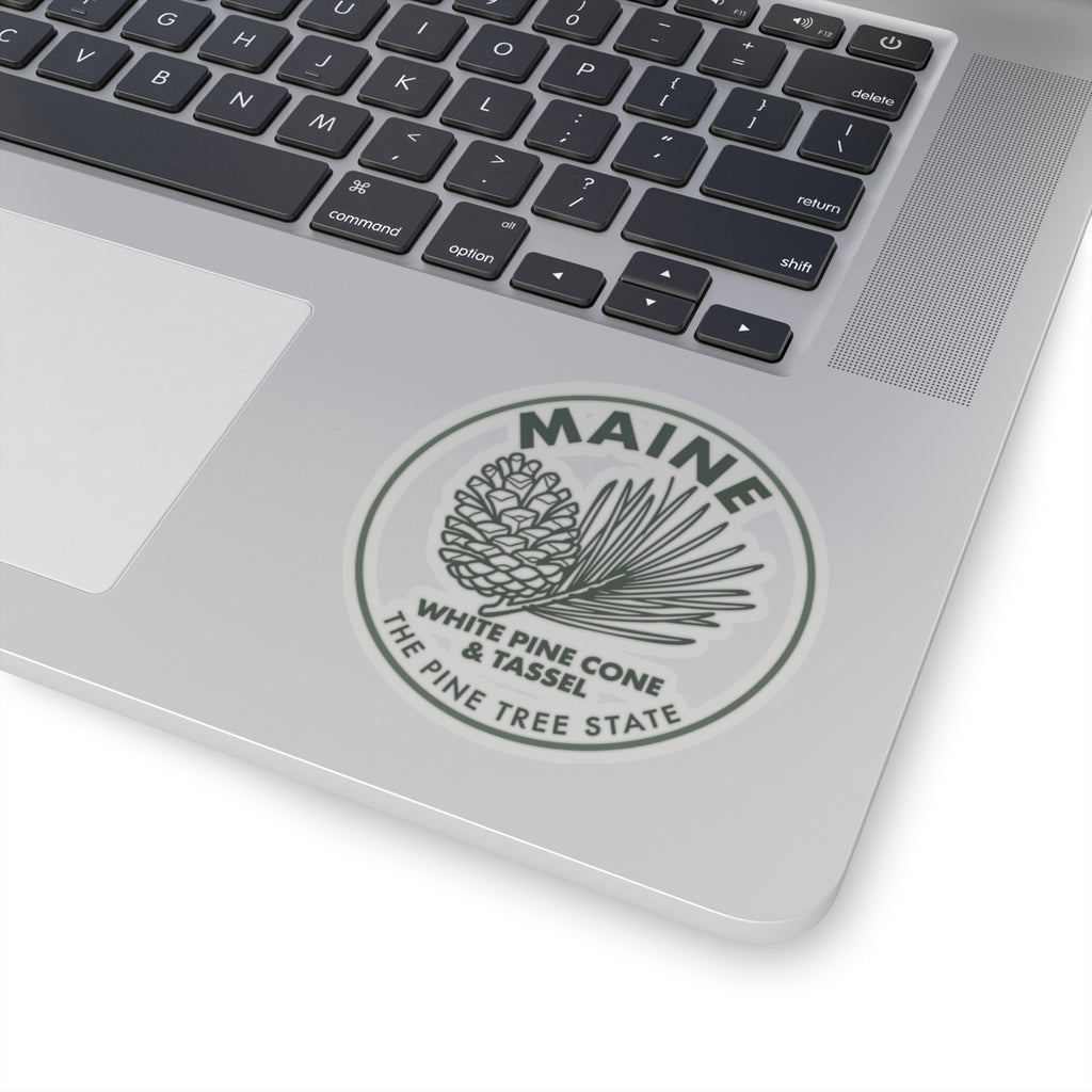 Maine white pine cone and tassel sticker centered on laptop lid, circular transparent vinyl decal