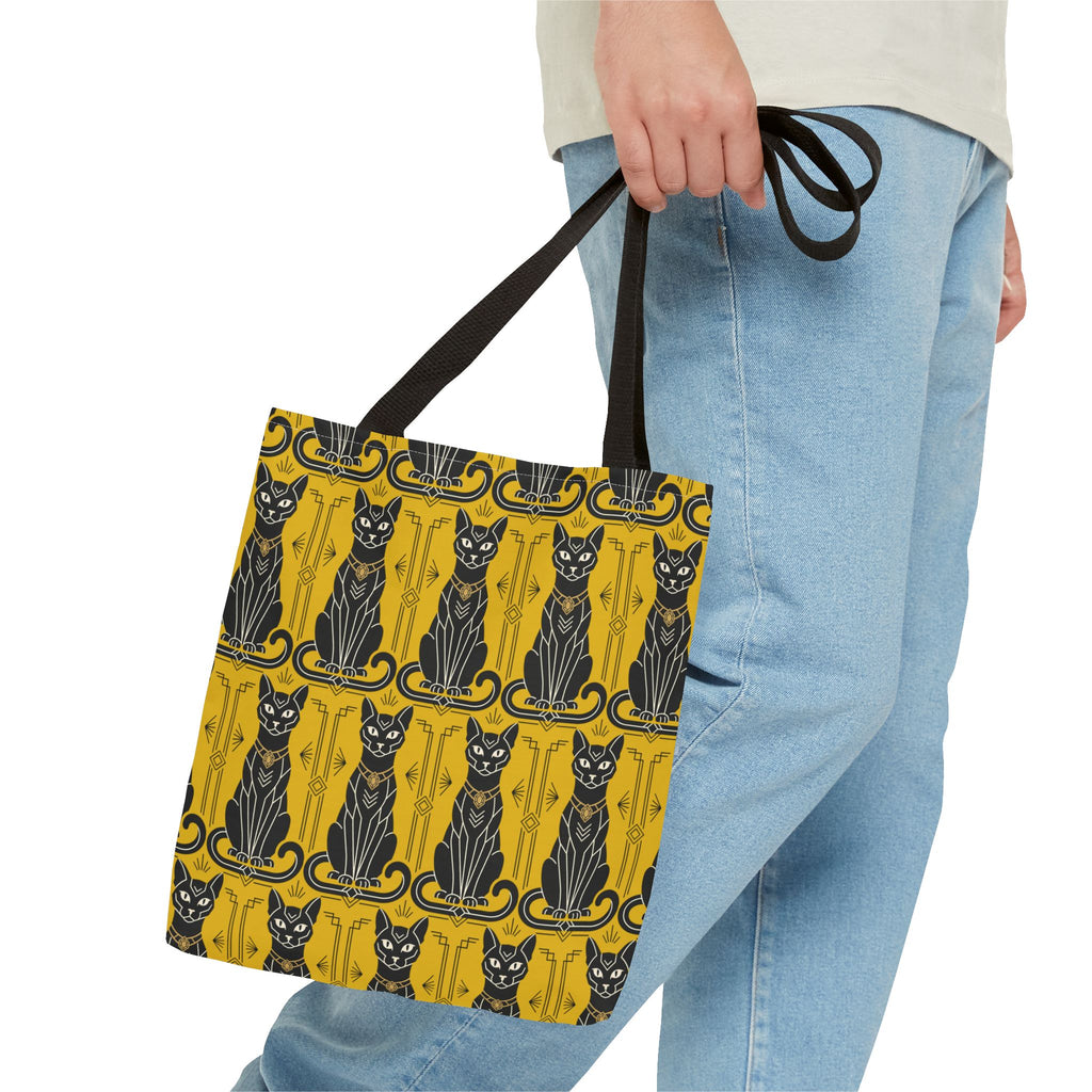 Yellow tote bag with black cat pattern and ornate border, held by black handles