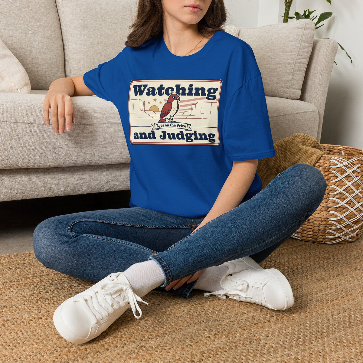 Royal blue T-shirt with "Watching and Judging" bird graphic