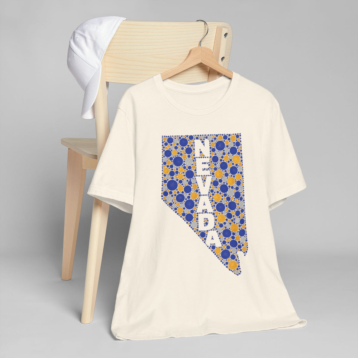 White crew-neck t-shirt with blue and gold patterned Nevada map graphic
