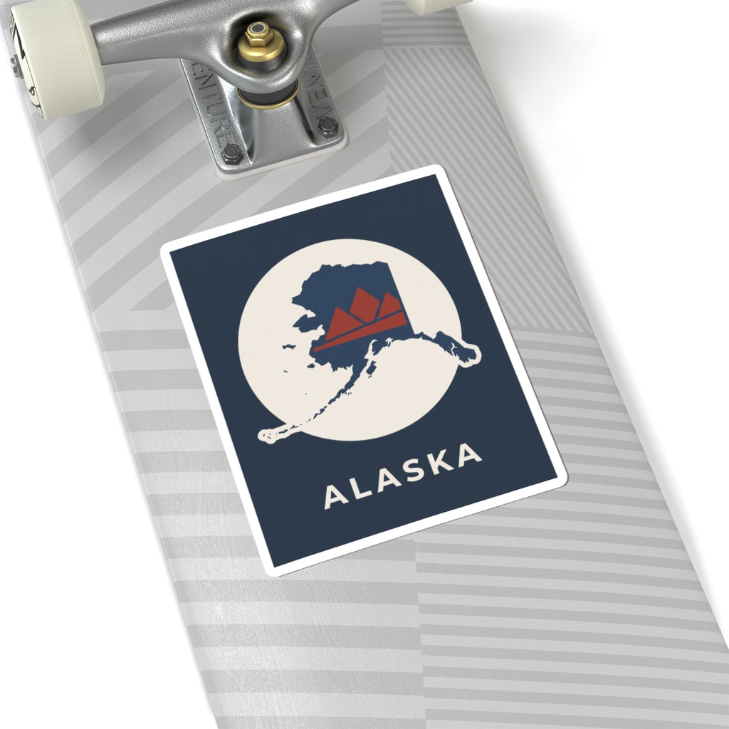 Alaska map badge sticker on luggage, retro mountain in red and navy on cream circle