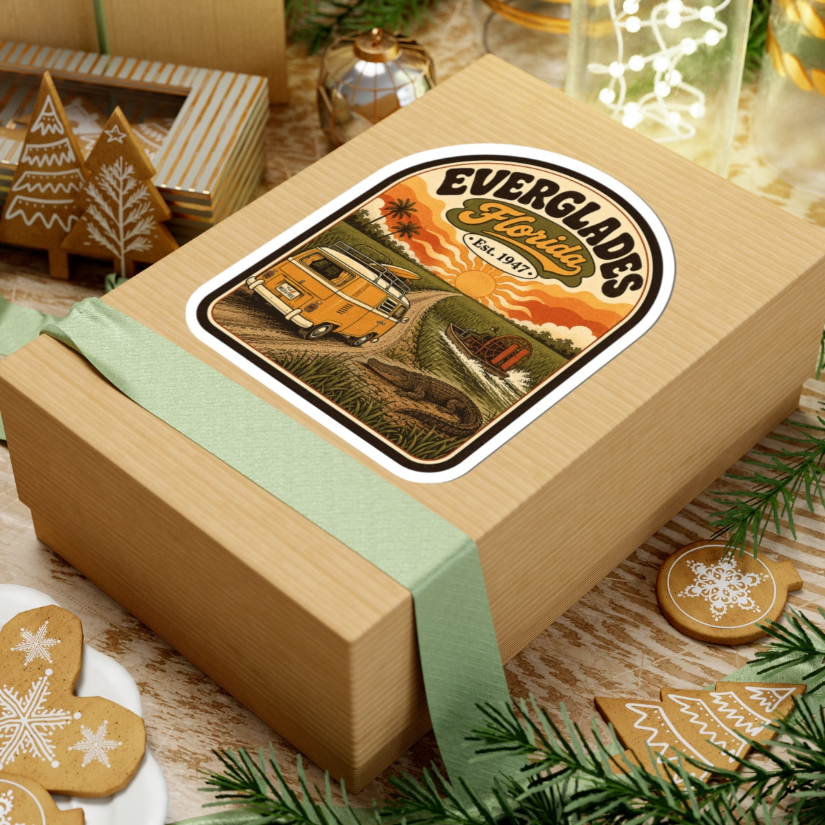 Everglades Florida vintage camper sticker on tan gift box with ribbon, orange van sunset artwork