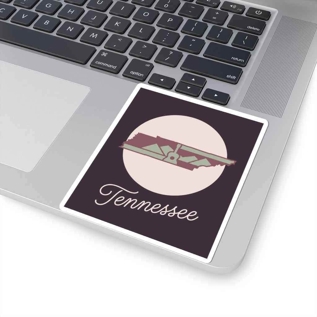 Tennessee sticker on laptop surface featuring state silhouette and “Tennessee”