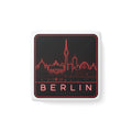 White square porcelain fridge magnet with red neon Berlin skyline and BERLIN text