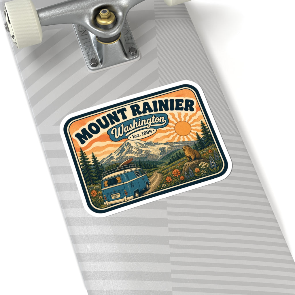 Mount Rainier sticker on light gray surface, vintage camper van, mountains, sun, bear