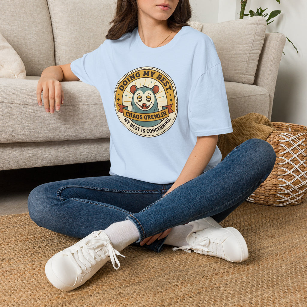 Light blue T-shirt with round 'Doing My Best Chaos Gremlin' cartoon badge on chest