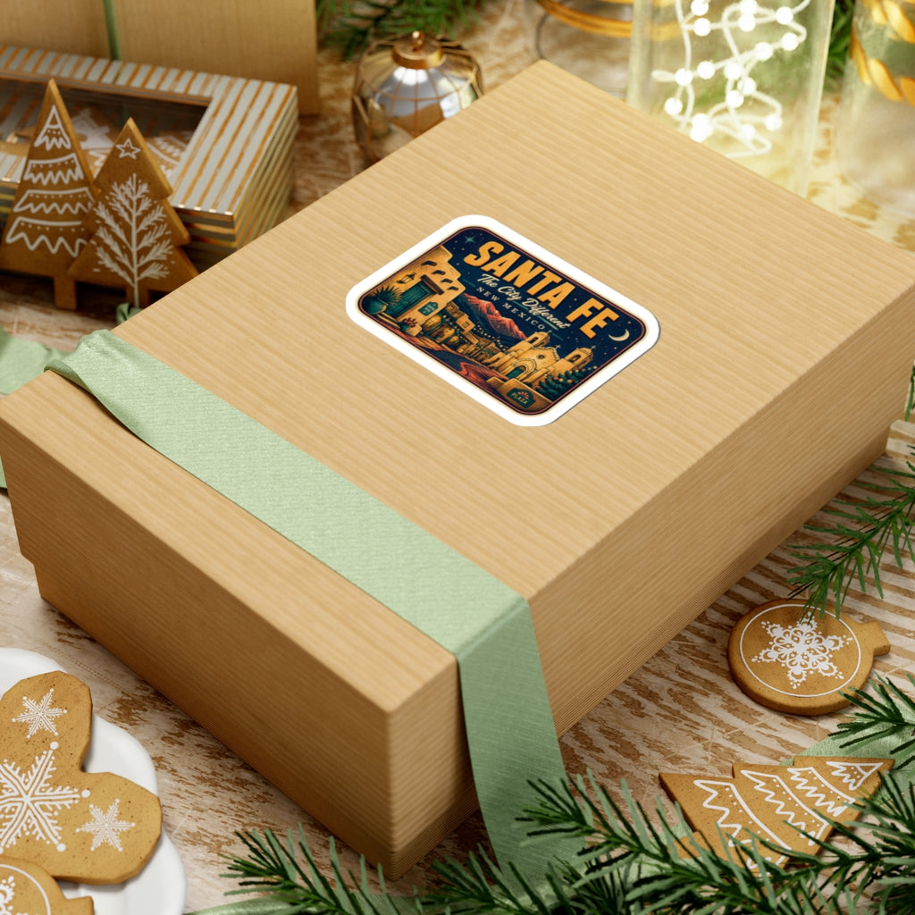 Santa Fe luggage tag sticker on a gift box, rectangular decal with “Santa Fe” and town scene.