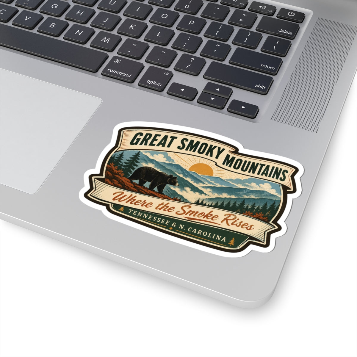 Great Smoky Mountains travel sticker on a laptop, sun over mountains and bear; “Where the Smoke Rises”