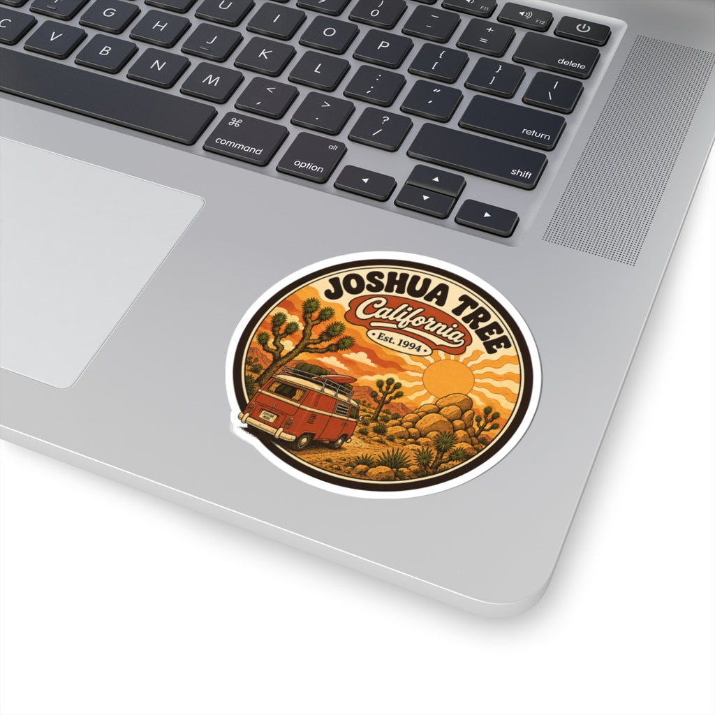 Round sticker with white border, Joshua Tree California Est. 1994, red camper in desert