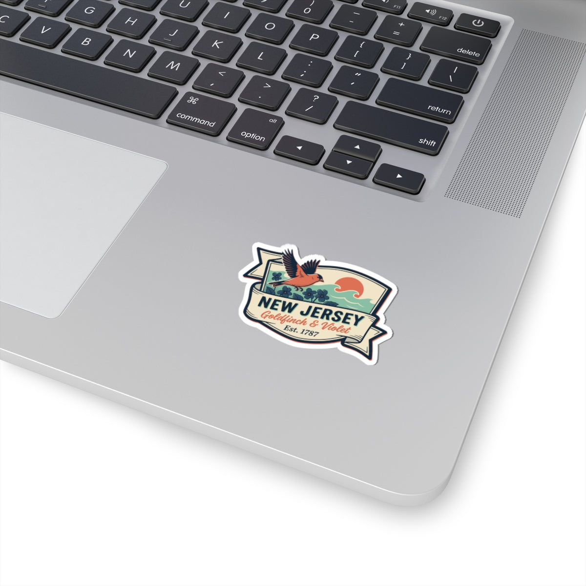 New Jersey vintage sticker on laptop lid, small badge with “Est. 1787” text.