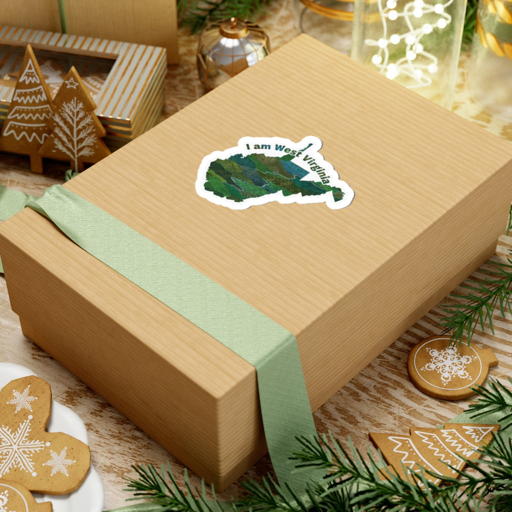 I am West Virginia sticker on wrapped gift with green ribbon and holiday decor