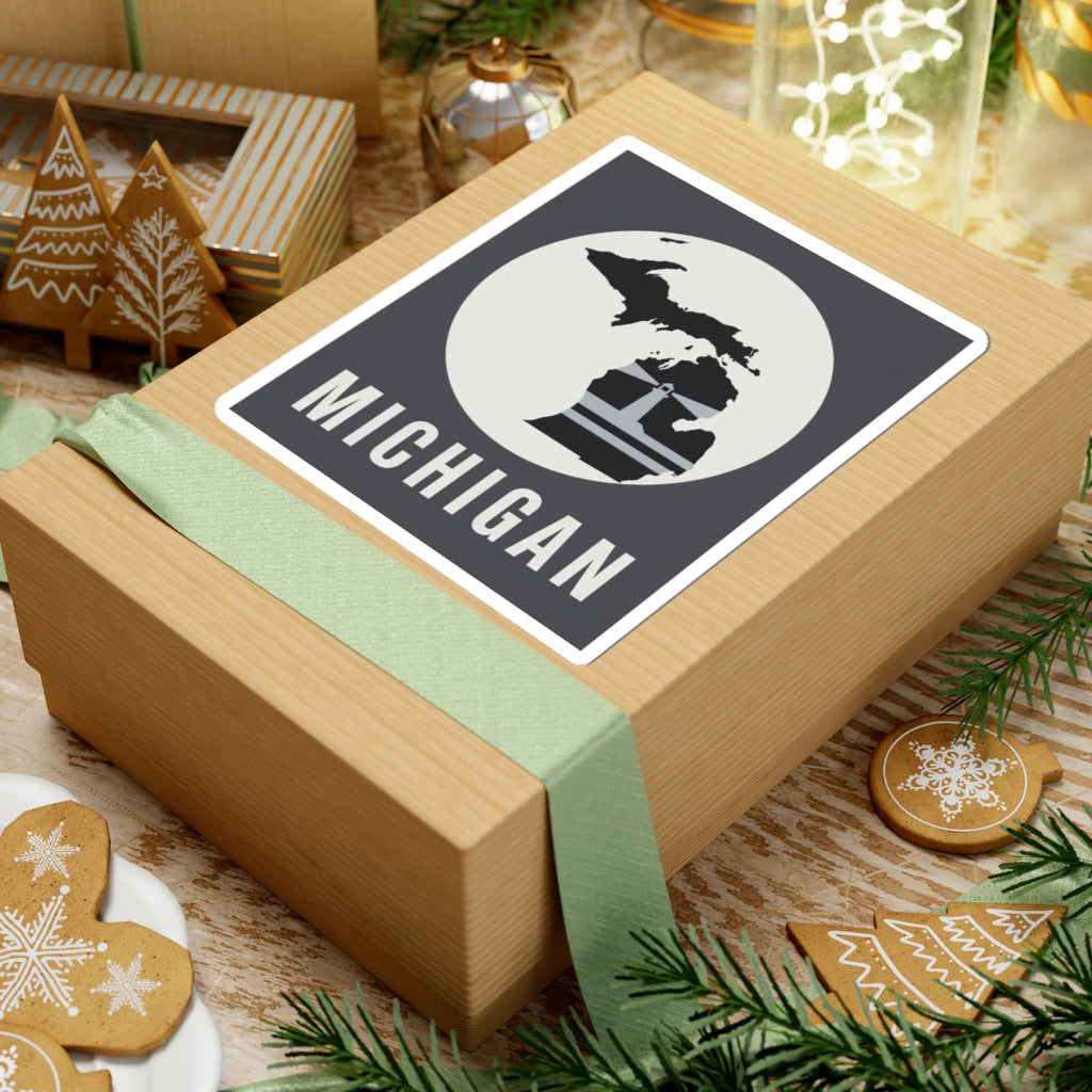 Michigan sticker on a wrapped gift, showing map silhouette, lighthouse graphic, and “MICHIGAN”.