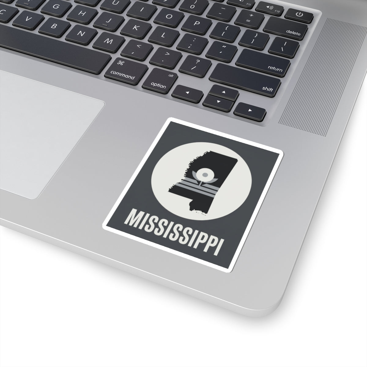 Mississippi silhouette kiss-cut sticker on laptop, circular emblem and “MISSISSIPPI”