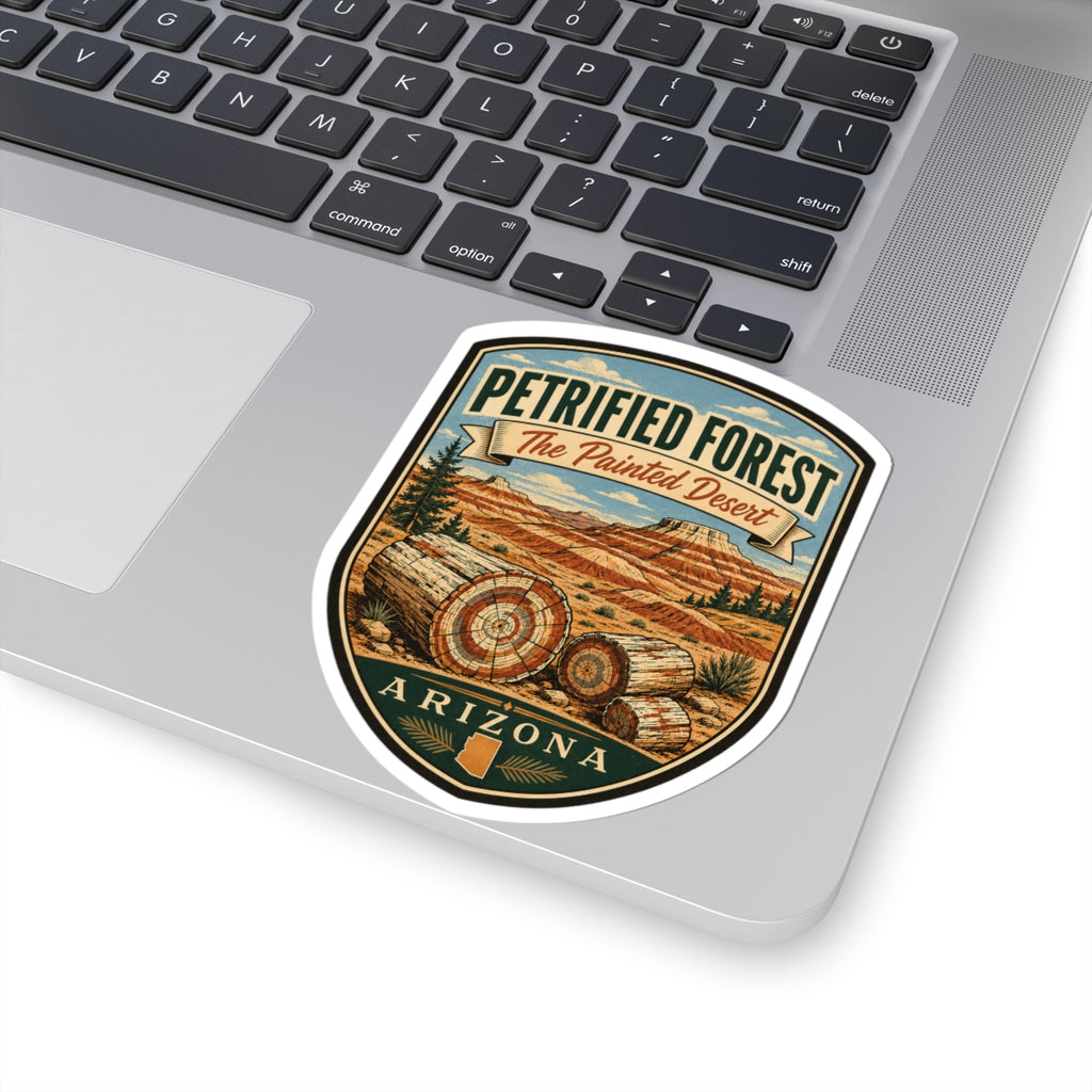 Petrified Forest travel sticker on laptop trackpad, shield badge with desert scene and Arizona