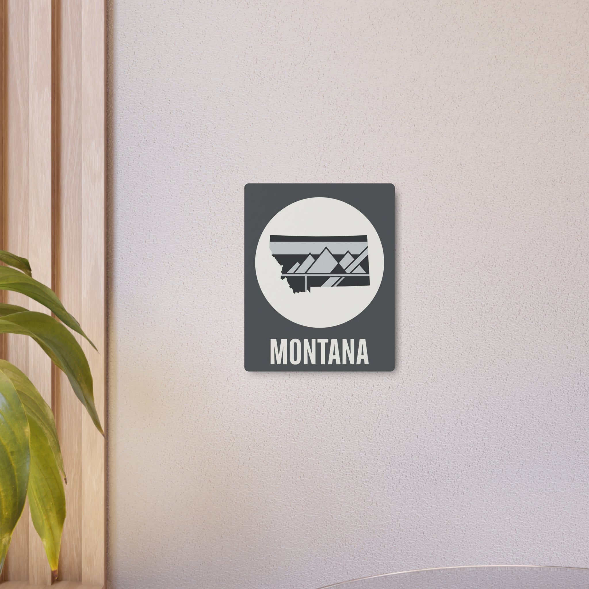 Mounted Montana state metal art sign with circular mountain graphic and “MONTANA” lettering