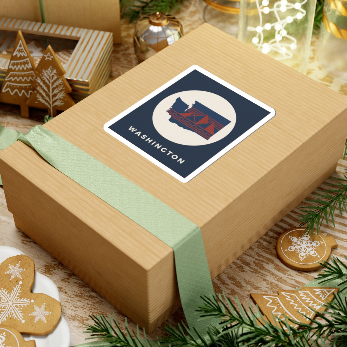 Washington graphic sticker on wrapped present, navy square with cream circle and red bridge design