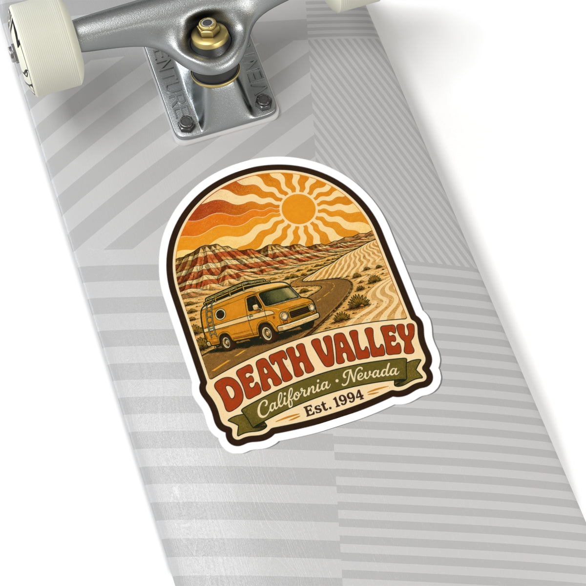 Kiss-cut sticker on skateboard deck with yellow camper van, Death Valley California Nevada Est. 1994