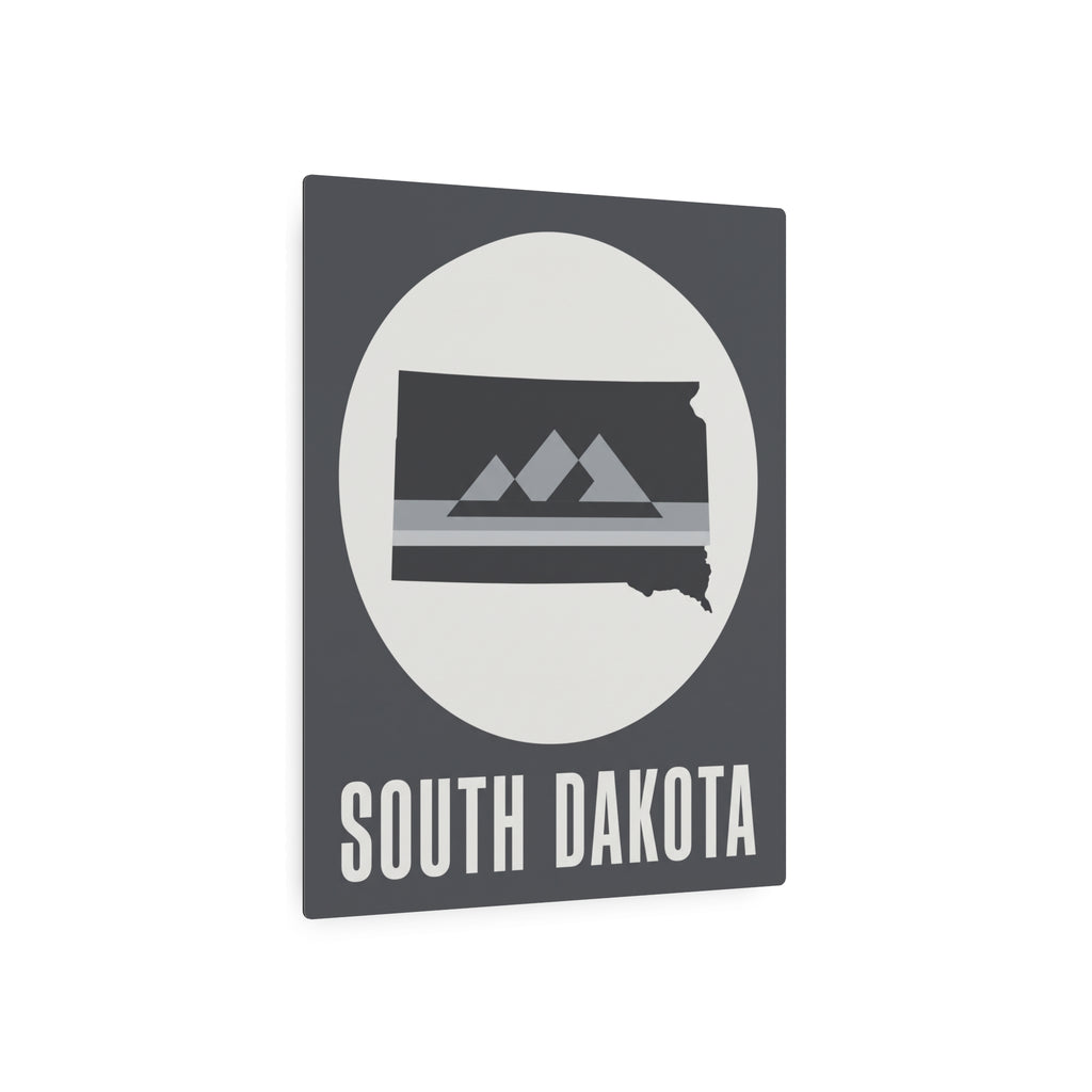 South Dakota metal wall sign, gray with oval mountain silhouette and 'SOUTH DAKOTA' title