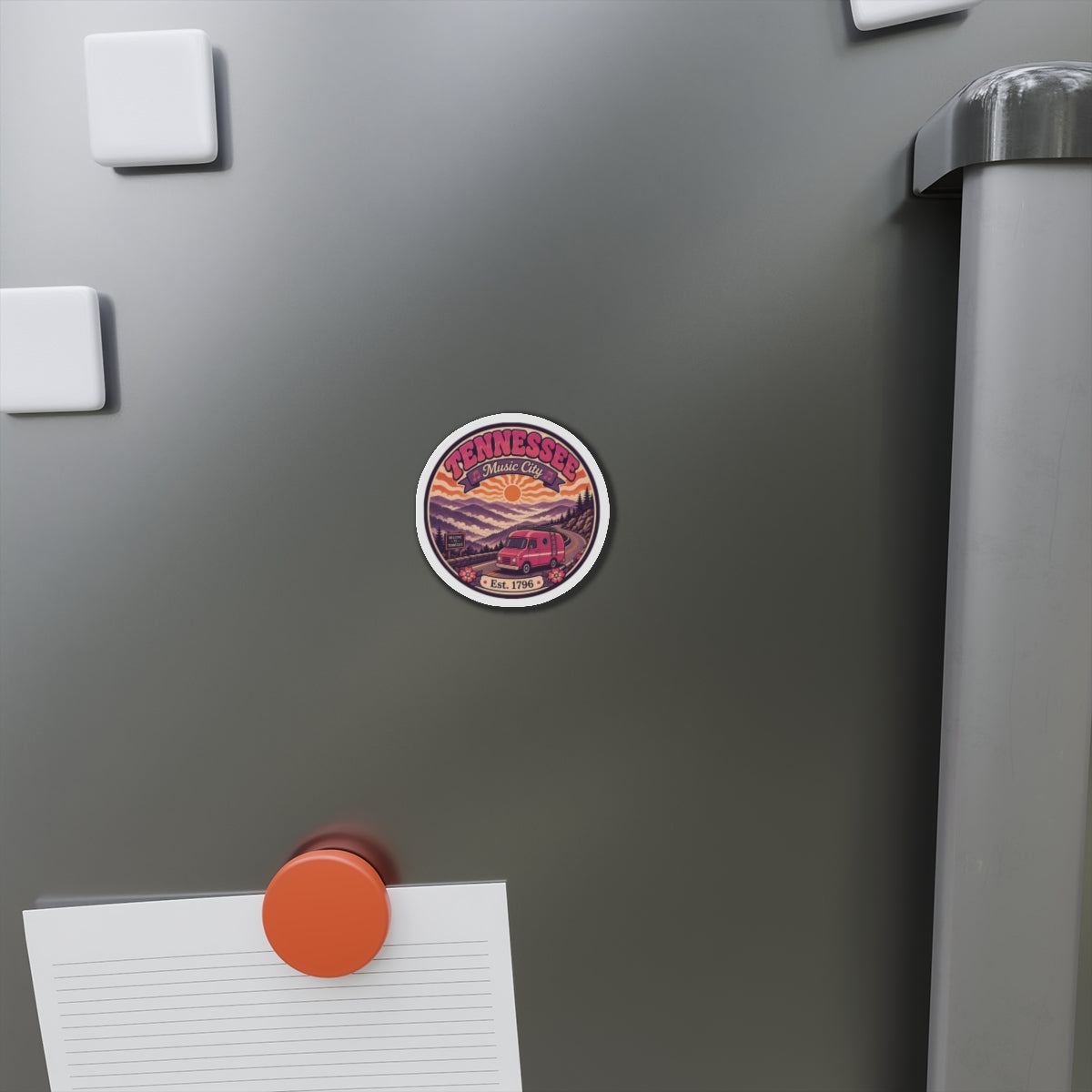 Tennessee Music City die-cut magnet stuck on a stainless refrigerator door, round scenic design.