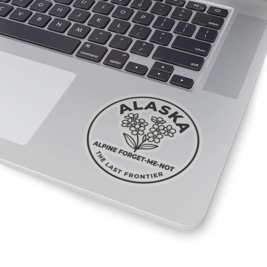 Alaska alpine forget-me-not vinyl sticker on laptop, round emblem with “ALASKA”