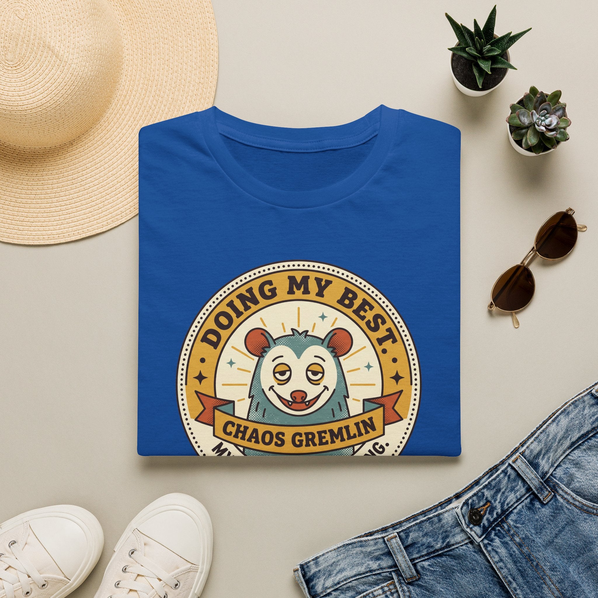 Royal blue t-shirt with “Doing My Best Chaos Gremlin” cartoon chest graphic