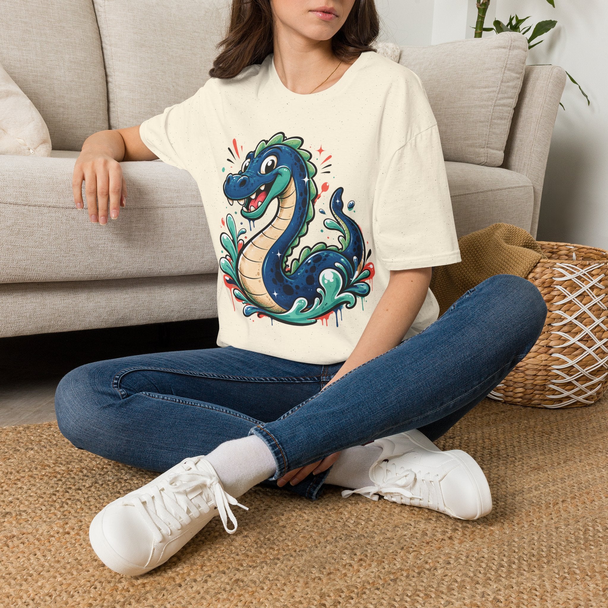 Cream crewneck T-shirt with colorful cartoon sea serpent graphic on front